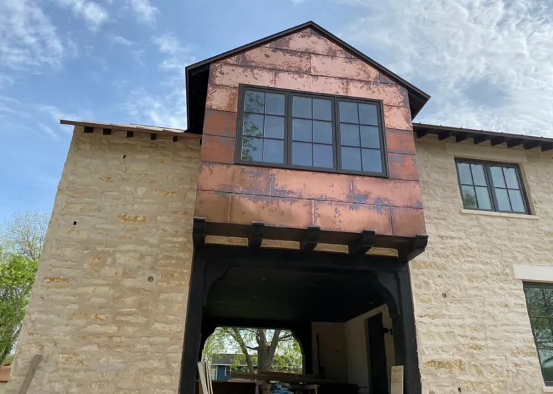 Copper metal panel facade on a stone building for Skylight Installation in West Columbia